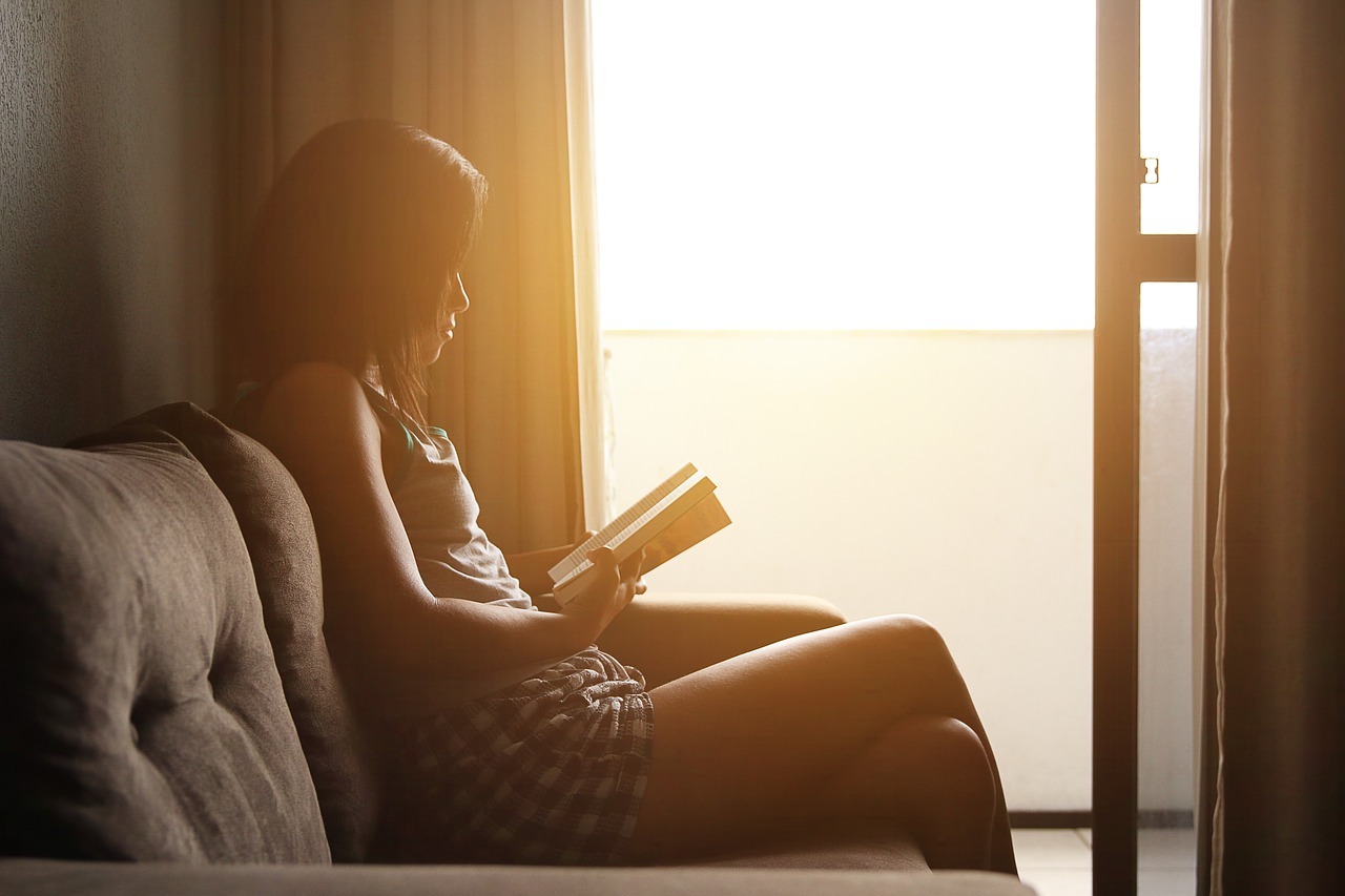 Girl reading in a well-lit study room